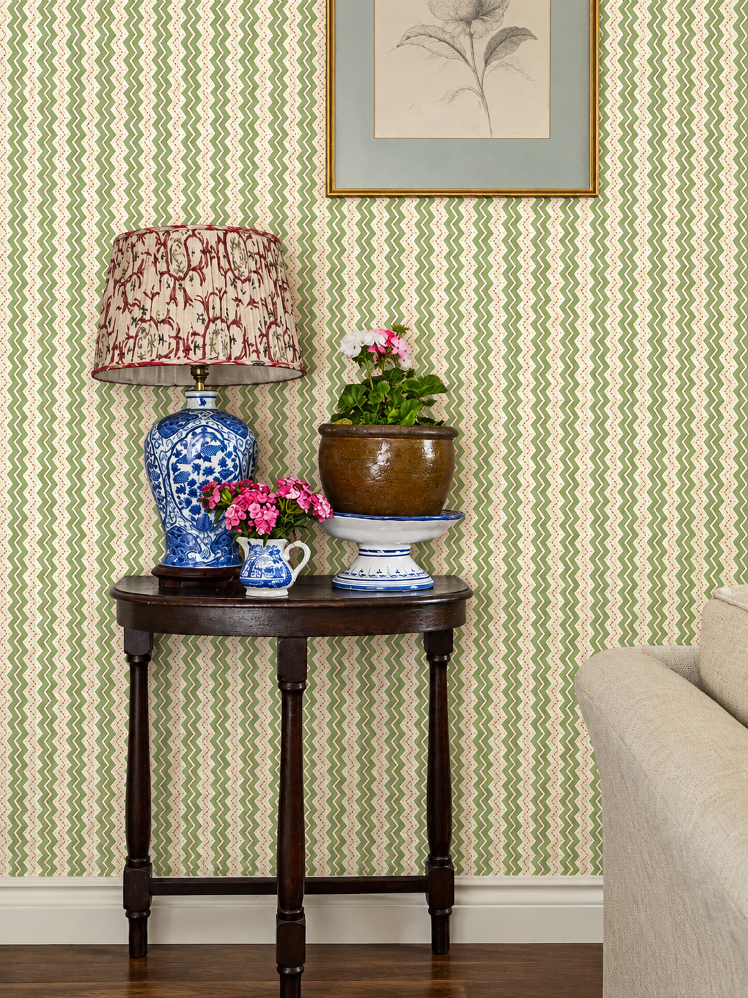 GP & J Baker patterned wallpaper with floral lampshade and blue porcelain lamp